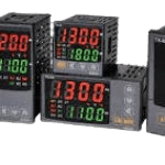 A group of four different temperature controllers.