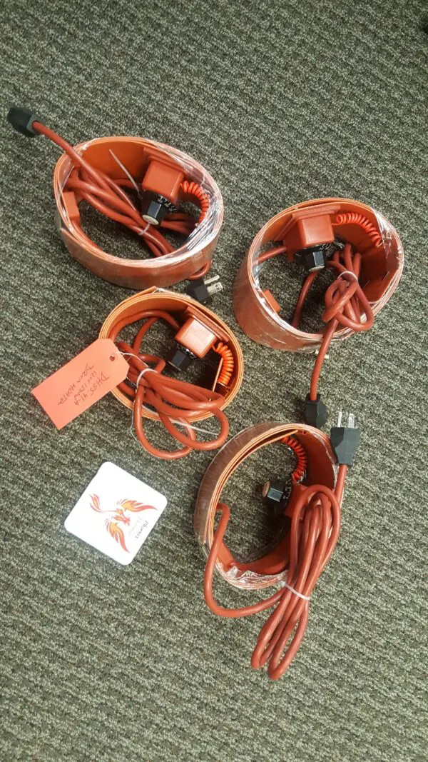 Four orange cords are wrapped around a pair of speakers.