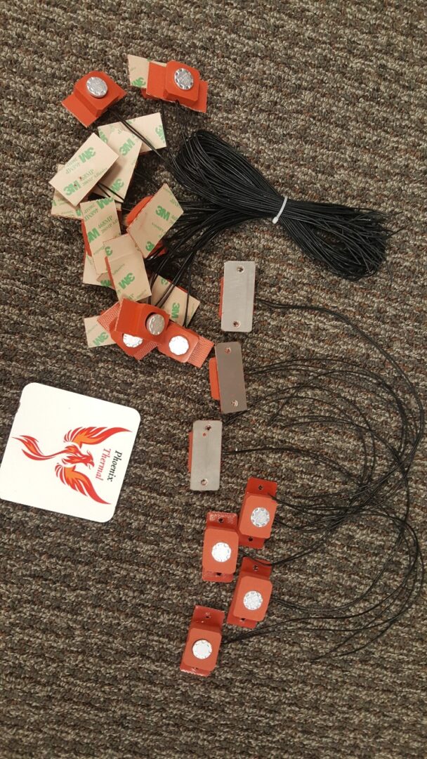 A bunch of cords and some cards on the floor