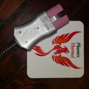 A pink and white coaster with a red dragon on it