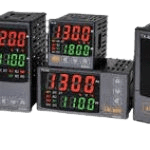 A group of four different temperature controllers.